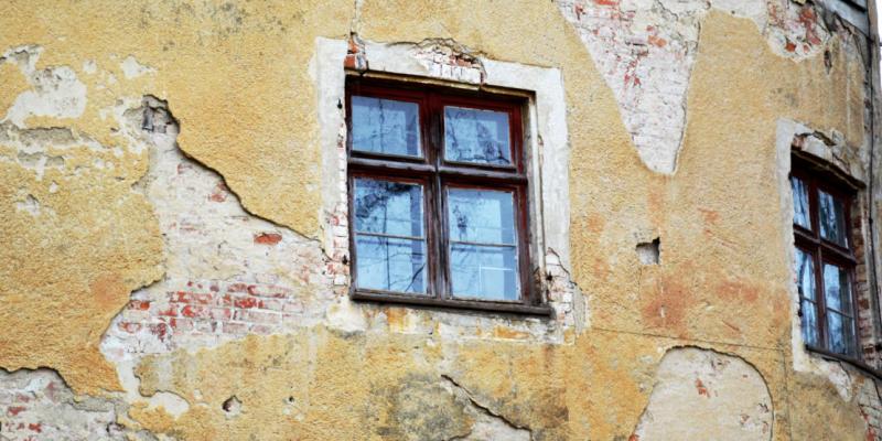 Historisches Fenster in einer beschädigten Fassade